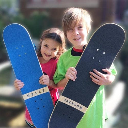 boy and girl showing customized skatexs kids skateboards with their name personalized on the deck