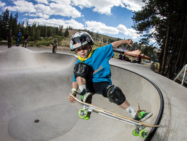 boy doing trick on skatexs kids skateboard at skatepark